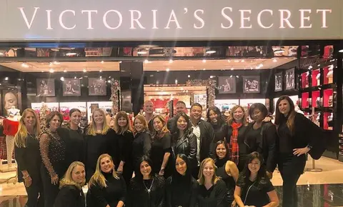 Staff in front of a Victoria's Secret store