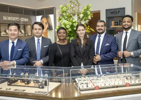 Staff standing at a counter in Watches of Switzerland