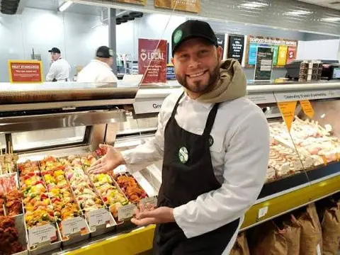 Team member pointing at a counter inside a Whole Foods store